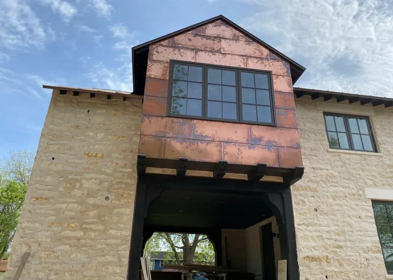 Copper metal panel facade on a stone building for Skylight Installation in Wallkill